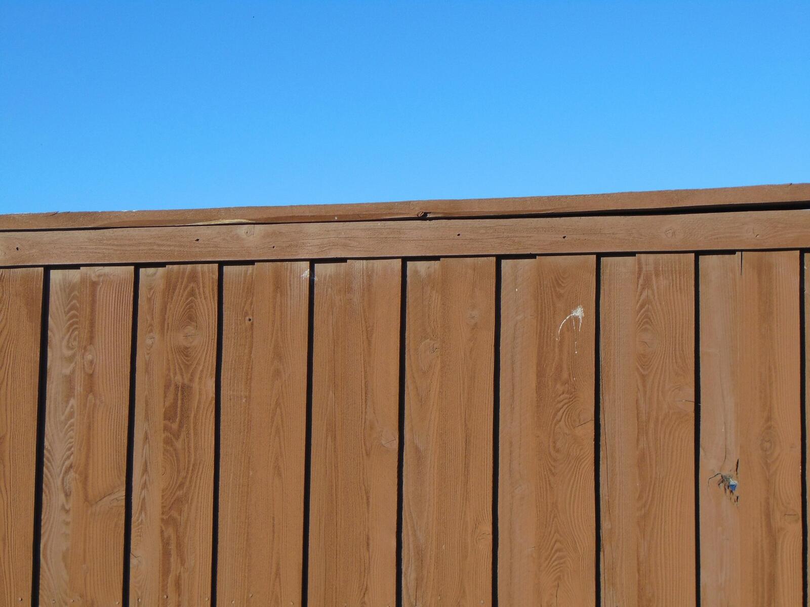 Close-up of a stained wooden privacy fence