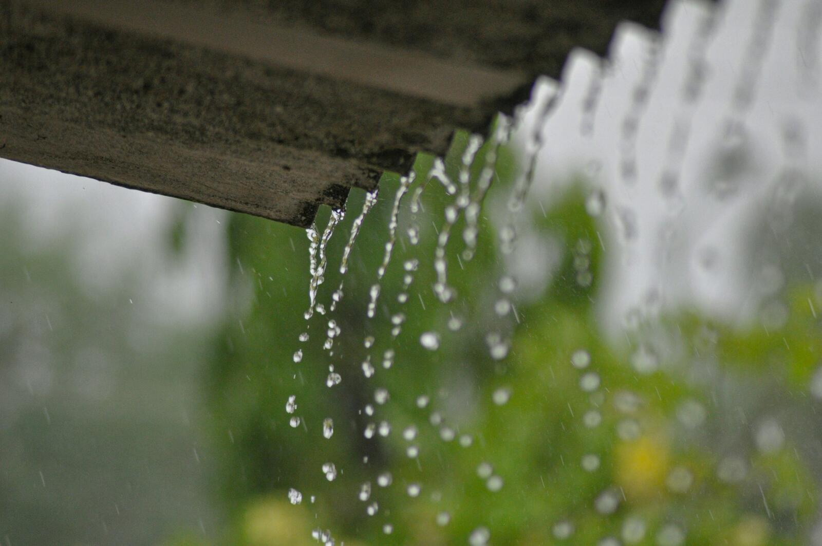 Rain water spilling over the edge of a gutter