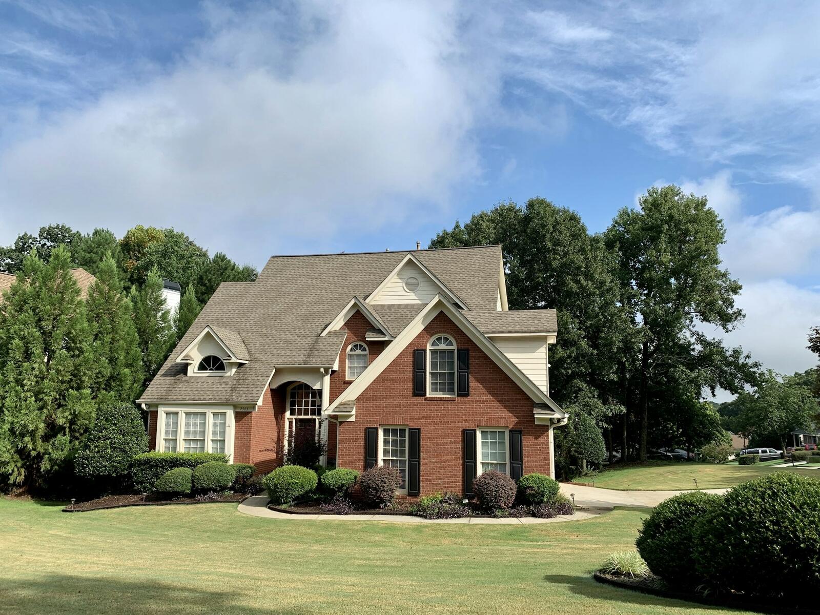 A clean roof on a brick home